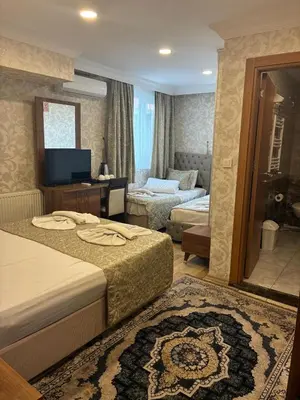 a hotel room with two beds and a living room at Angels Garden Hotel - Special Catagory in Istanbul