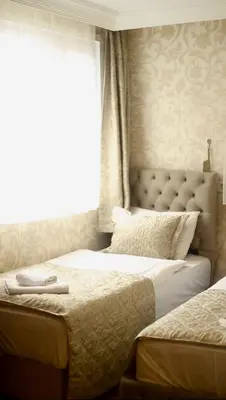 two twin beds in a bedroom with a window at Angels Garden Hotel - Special Catagory in Istanbul