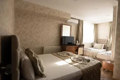 a hotel room with a bed and a television at Angels Garden Hotel - Special Catagory in Istanbul