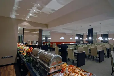 a restaurant with tables and chairs and a buffet at Klas Hotel Istanbul Old City in Istanbul