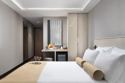 a bedroom with a large white bed with a desk at Pianoforte by Febor Hotels&Spa in Istanbul