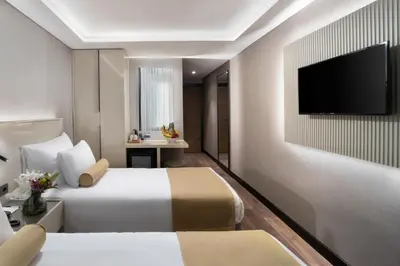 a hotel room with two beds and a flat screen tv at Pianoforte by Febor Hotels&Spa in Istanbul
