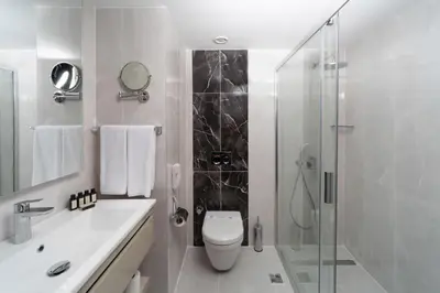 a bathroom with a toilet and a glass shower at Pianoforte by Febor Hotels&Spa in Istanbul