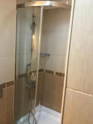 a shower with a glass door in a bathroom at Berce Apartments in Istanbul