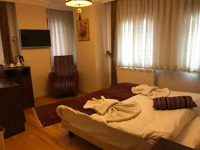 a bedroom with a bed with towels on it at Berce Apartments in Istanbul