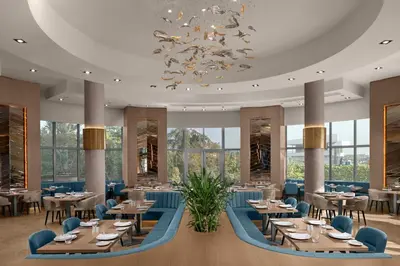 a restaurant with tables and chairs and a chandelier at Delta Hotels Istanbul West in Istanbul