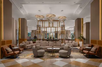 a lobby with couches and tables and a chandelier at Delta Hotels Istanbul West in Istanbul