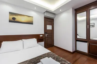 a bedroom with a bed and a sliding door at Buyukada Comfort OTEL in Buyukada