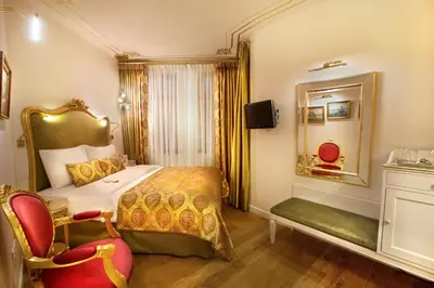 a hotel room with a bed and a chair at Valide Sultan Konagi in Istanbul
