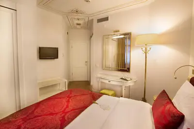 a bedroom with a bed and a sink and a mirror at Valide Sultan Konagi in Istanbul