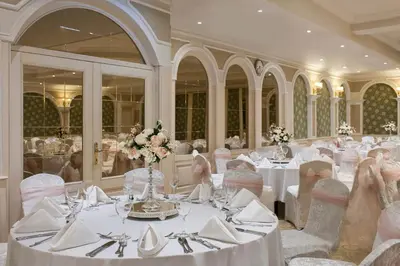 a banquet hall with white tables and chairs and flowers at Elite World Comfy Istanbul Taksim in Istanbul