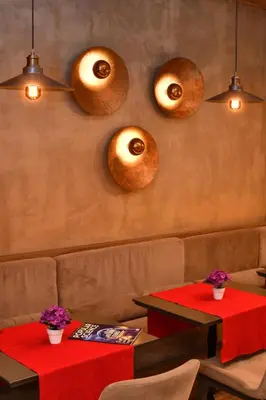 a restaurant with two tables and two donuts on the wall at The Pera Hotel in Istanbul