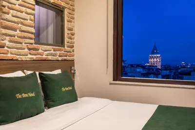 a bedroom with a window with a view of the city at The Pera Hotel in Istanbul