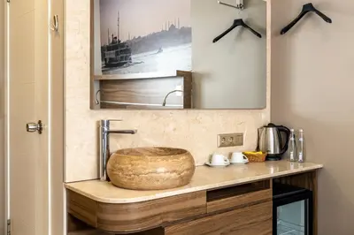a bathroom sink with a wooden bowl on a counter at The Pera Hotel in Istanbul
