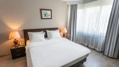 a bedroom with a large bed and a large window at The Marmara Suadiye Residence in Istanbul