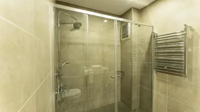 a shower with a glass door in a bathroom at The Marmara Suadiye Residence in Istanbul