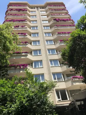 a tall apartment building with pink flowers on the balconies at The Marmara Suadiye Residence in Istanbul