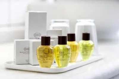 a shelf with four bottles of yellow perfume at Grand Halic Goldenhorn in Istanbul