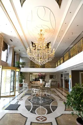 a large lobby with a chandelier and a table at Grand Halic Goldenhorn in Istanbul