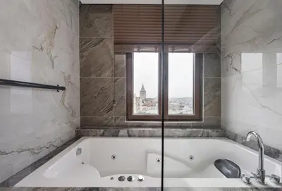 a bath tub in a bathroom with a window at Continental Hotel Pera in Istanbul