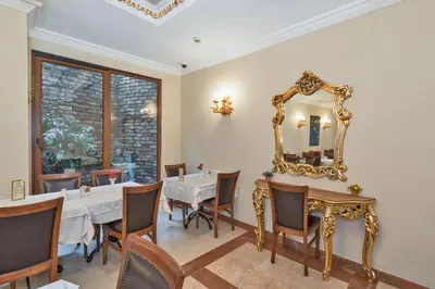 a dining room with a table and a mirror at Antis Hotel-Special Category in Istanbul
