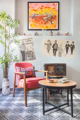a living room with a red chair and a table at Hotel Poem in Istanbul