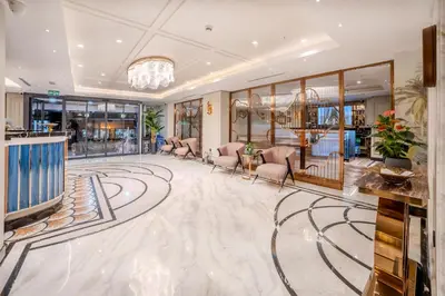 a lobby of a hotel with chairs and a chandelier at Grand Hilarium Hotel in Istanbul