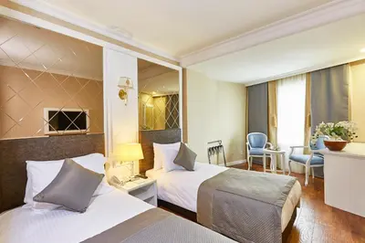 a hotel room with two beds and a living room at Seres Hotel Old City in Istanbul