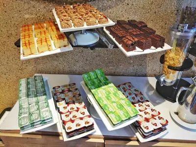 a table with many different types of cakes and pastries at Orient Mintur Hotel in Istanbul