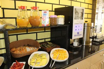 a buffet with plates of food and bottles of orange juice at Theodian Hotel in Istanbul