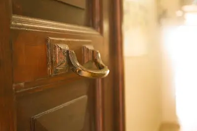 a wooden door with a brass door knocker on it at Theodian Hotel in Istanbul