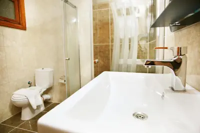 a bathroom with a sink and a toilet at Theodian Hotel in Istanbul