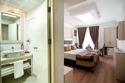 a hotel room with a bed and a sink at Royce Hotel in Istanbul