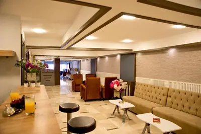 a lobby with a couch and tables and chairs at Royce Hotel in Istanbul