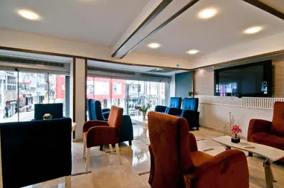 a waiting room with chairs and a flat screen tv at Royce Hotel in Istanbul