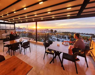 a restaurant with tables and chairs and a view of the city at Saruhan Hotel in Istanbul