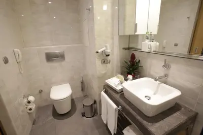 a white bathroom with a sink and a toilet at Housez Suites & Apartments Special Class in Istanbul