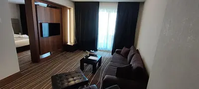 a living room with a couch and a television at Cihangir Hotel Bosphorus in Istanbul
