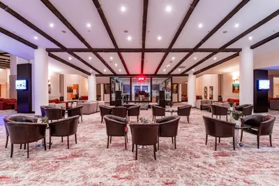 a lobby with tables and chairs and a bar at Monte Baia Uludağ in Uludag