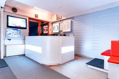 a lobby with a white counter and a television at Monte Baia Uludağ in Uludag