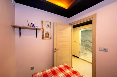 a room with a bed and a door to a hallway at Harmony Hotel Istanbul & SPA in Istanbul