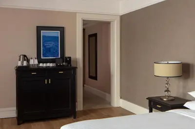 a bedroom with a black dresser and a bed at Istanbul Marriott Hotel Pendik in Istanbul