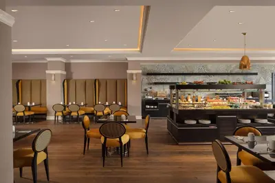a restaurant with tables and chairs and a bar at Istanbul Marriott Hotel Pendik in Istanbul