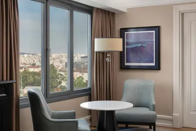 a hotel room with a table and chairs and a window at Istanbul Marriott Hotel Pendik in Istanbul