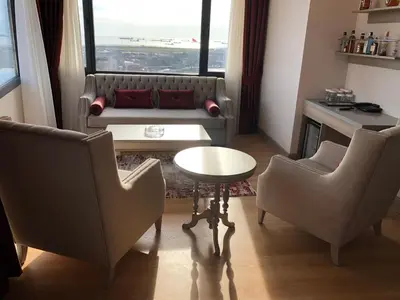 a living room with a couch and a table and two chairs at Aspen Hotel & SPA Istanbul Old City in Istanbul
