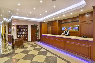 a man sitting at a bar in a hotel lobby at Aspen Hotel & SPA Istanbul Old City in Istanbul
