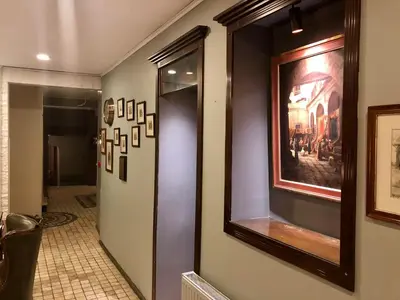 a hallway with paintings on the walls of a room at Hotel Fehmi Bey - Special Category in Istanbul