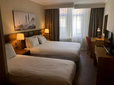 a hotel room with two beds and a television at Hotel Fehmi Bey - Special Category in Istanbul