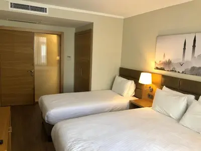 a hotel room with two beds and a window at Hotel Fehmi Bey - Special Category in Istanbul