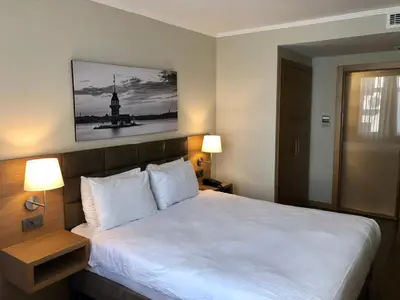 a bedroom with a white bed with two lamps at Hotel Fehmi Bey - Special Category in Istanbul